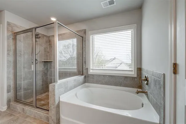 a white bath tub sitting next to a shower