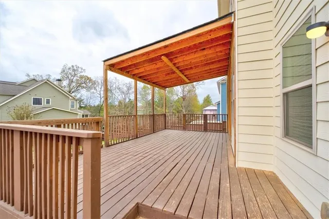 a view of balcony with wooden floor and fence