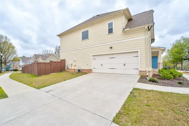 a view of a house with a yard and garage