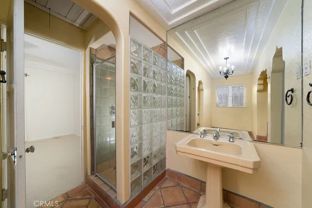 a bathroom with a sink a mirror and a shower