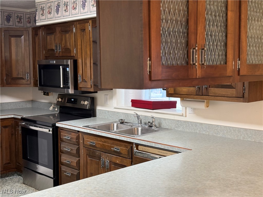 68697 Morristown Flushing Road Flushing, OH 43977 - Photo 14 of 33 Kitchen featuring light countertops, appliances with stainless steel finishes, and a sink