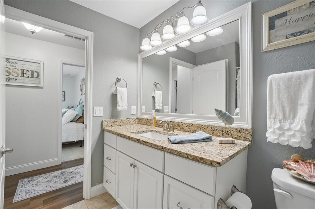 3934 Connersville Road Bartow, FL 33830 - Photo 47 of 81 a bathroom with a granite countertop sink a toilet and a mirror