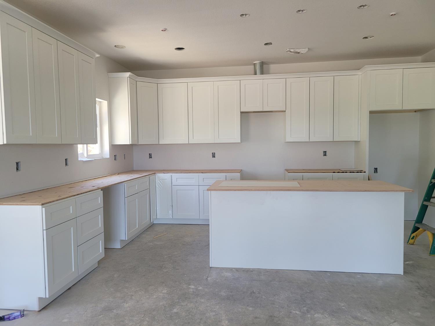 2307 Arrowhead Street Copperopolis, CA 95228 - Photo 7 of 32 a kitchen with cabinets a sink a window and stainless steel appliances