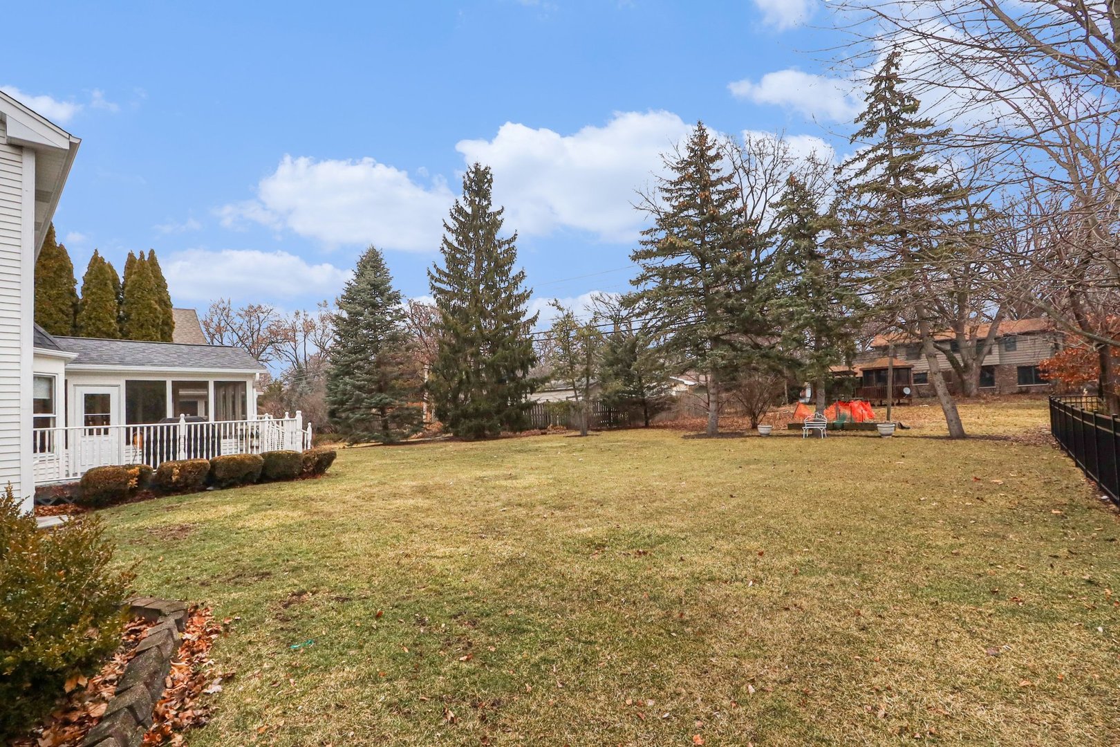570 Violet Lane Batavia, IL 60510 - Photo 24 of 28 a backyard of a house with table and chairs plants and large trees