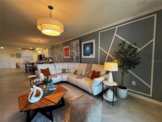 a living room with furniture a flat screen tv and a large window