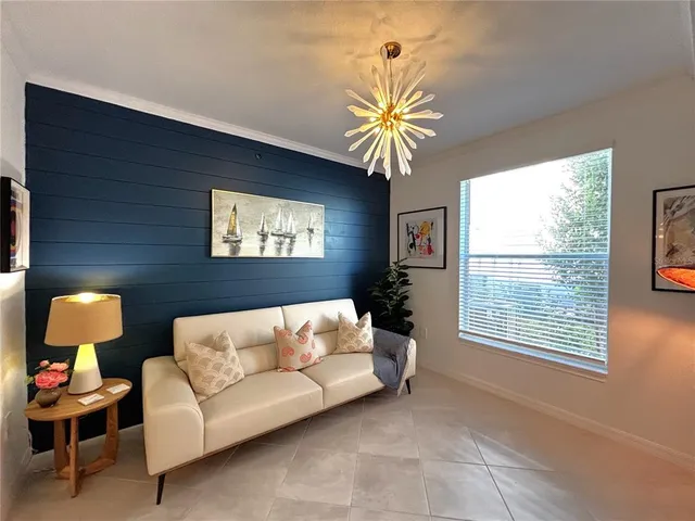 a living room with furniture and floor to ceiling window
