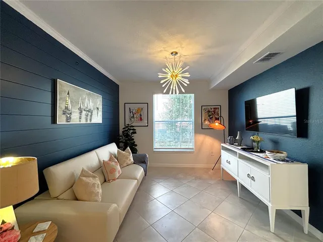a living room with couch and a floor to ceiling window