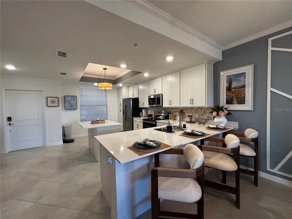 a bedroom with a large bed and a flat tv screen on dresser