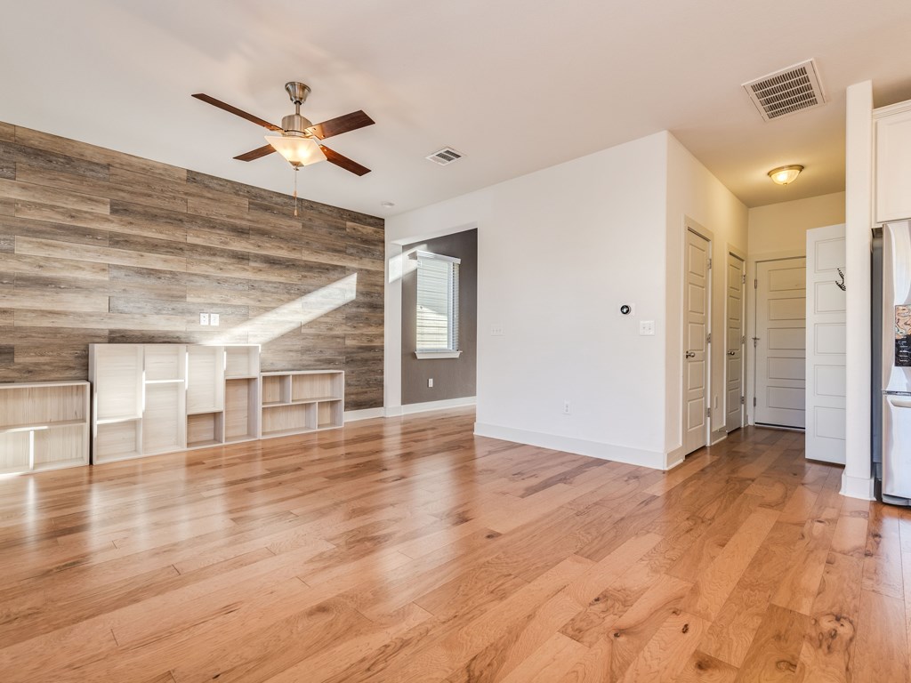 2208 Capulet Street Austin, TX 78741 - Photo 5 of 23 a view of empty room with wooden floor and fan