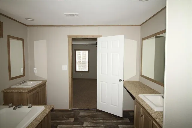 a view of hallway with sink and wooden floor