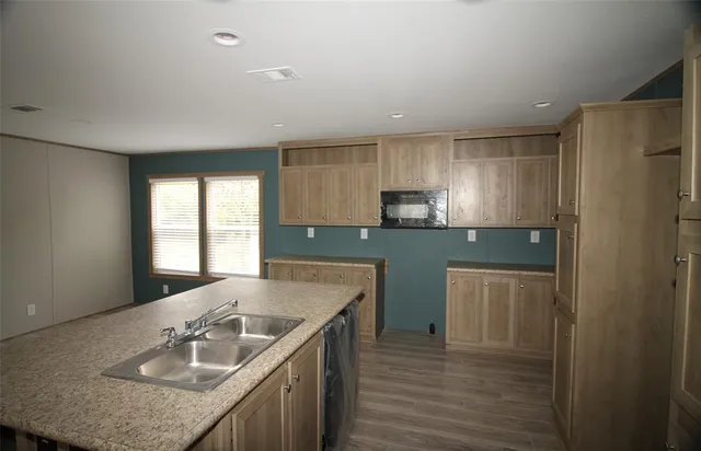 a kitchen with a sink a stove a refrigerator and cabinets