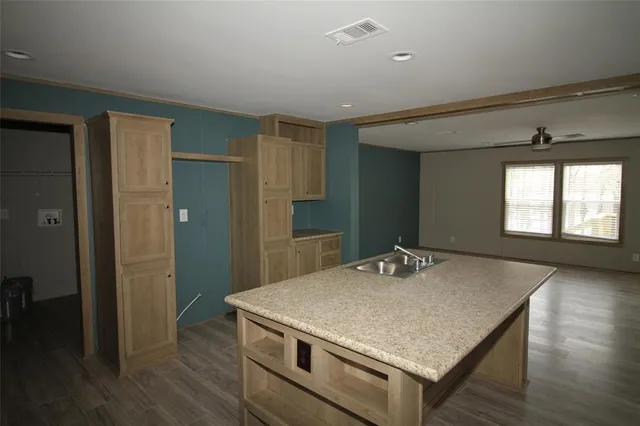 a kitchen with kitchen island a sink stove and refrigerator