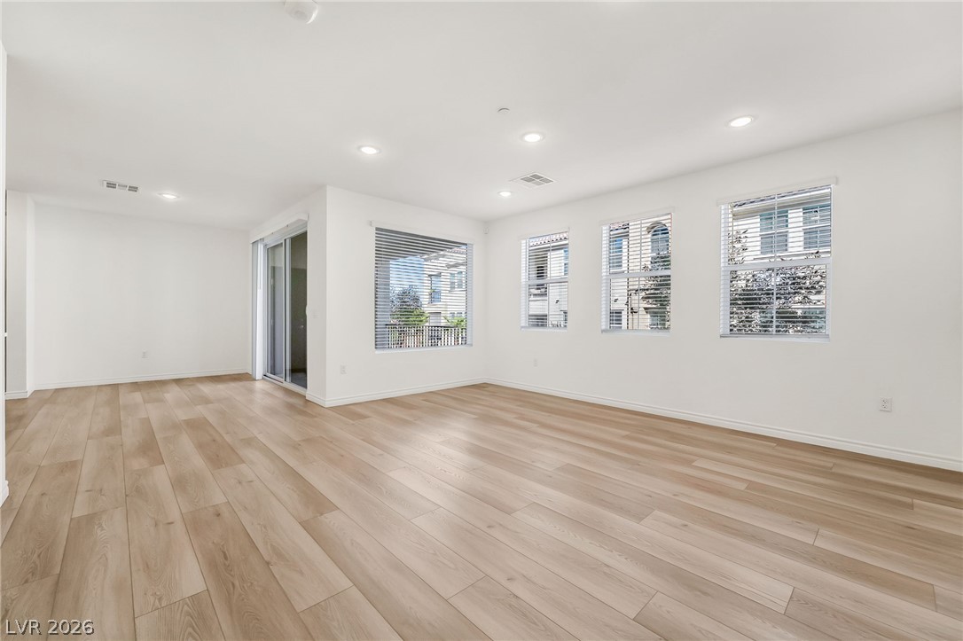 2555 Hampton Road, Unit 10108 Henderson, NV 89052 - Photo 5 of 23 Recessed lighting and warm wood-style flooring elevate this versatile open-concept living space.