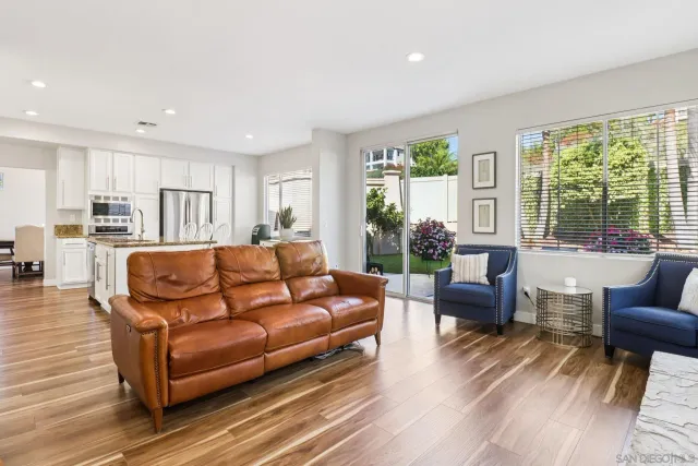 a view of a dining room with furniture wooden floor and chandelier