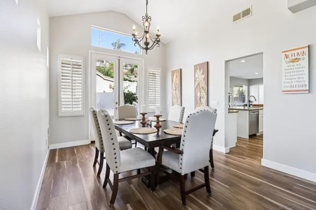 a view of a dining room with furniture wooden floor and a fireplace