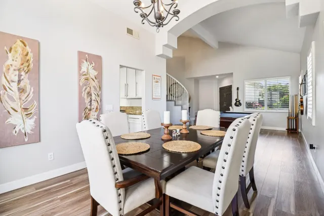 a kitchen with stainless steel appliances a refrigerator a stove a sink dishwasher and a refrigerator with wooden floor