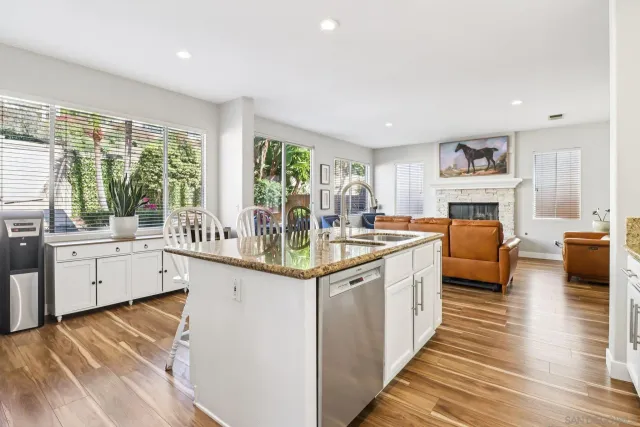 a view of a dining room with furniture and a chandelier