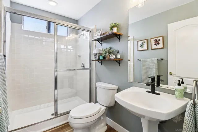 a bedroom with a bed and large windows