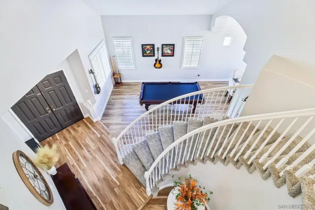 a room with pool table and windows