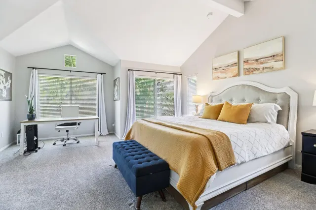 a bedroom with a bed lamp closet and window