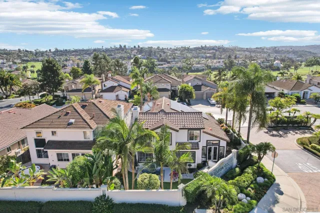 an aerial view of residential houses with city view