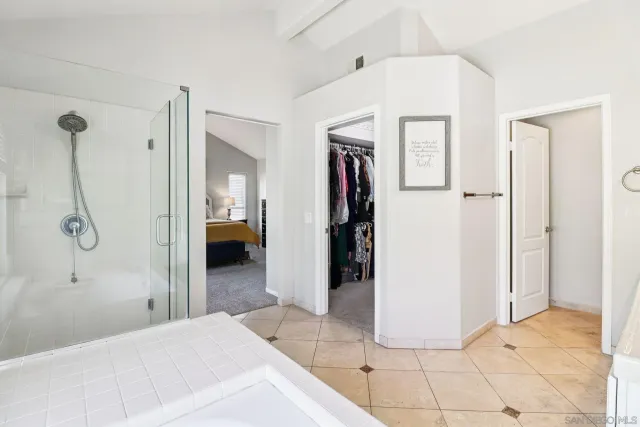 a bedroom with a bed and painting on the wall