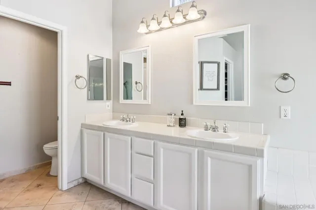 a bedroom with a bed and painting on the wall