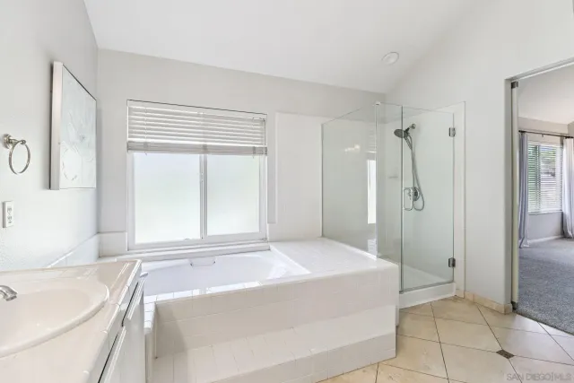 a bedroom with a large bed and a tv