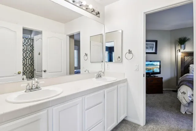 a bedroom with a bed and a painting on the wall