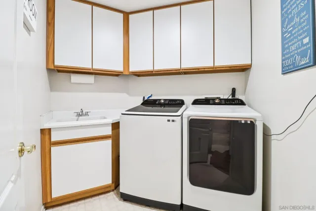 a view of a backyard with table and chairs and potted plants