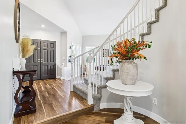 a view of entryway and hall with wooden floor