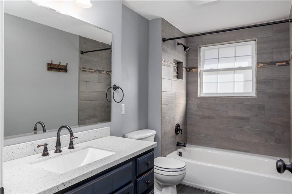 166 Country Club Road Washington, PA 15301 - Photo 17 of 32 a bathroom with a granite countertop sink toilet and shower