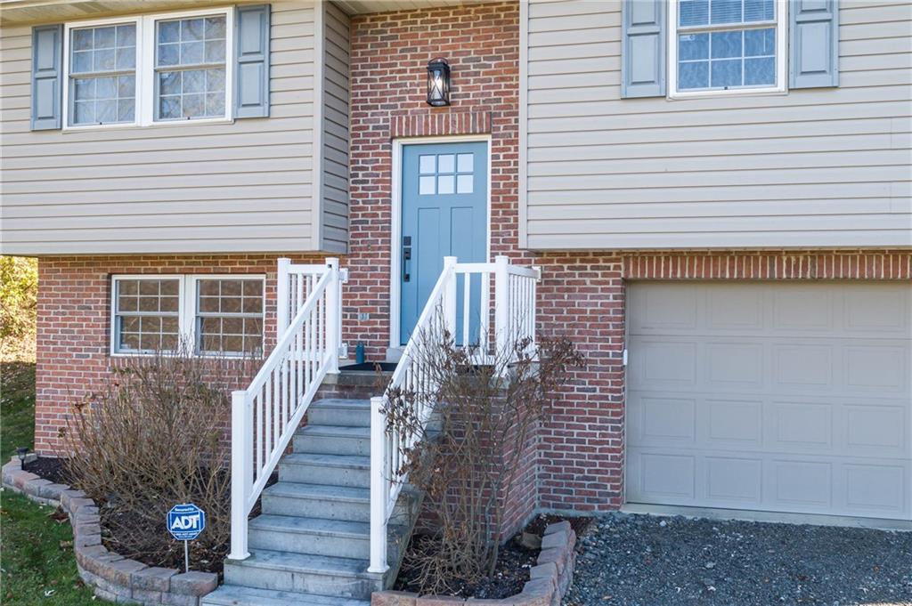 166 Country Club Road Washington, PA 15301 - Photo 3 of 32 a view of a brick house with wooden stairs