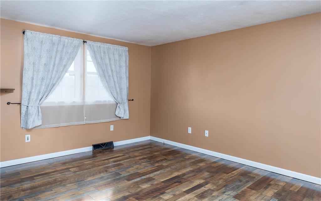 166 Country Club Road Washington, PA 15301 - Photo 5 of 32 a view of an empty room with wooden floor and a window