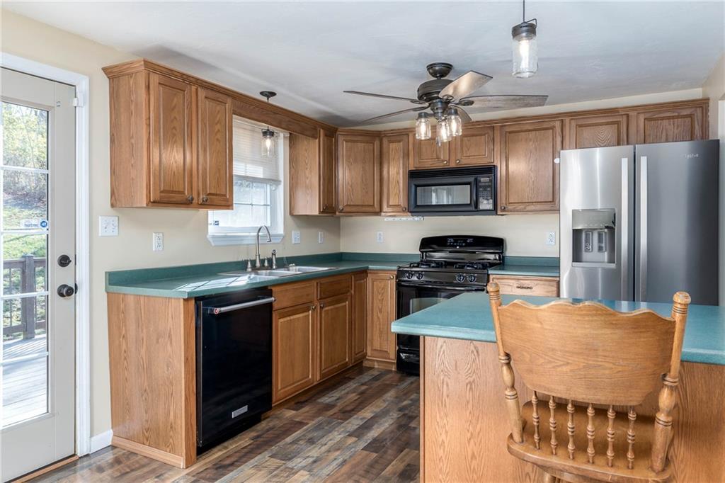 166 Country Club Road Washington, PA 15301 - Photo 8 of 32 a kitchen with stainless steel appliances granite countertop a stove refrigerator sink and microwave