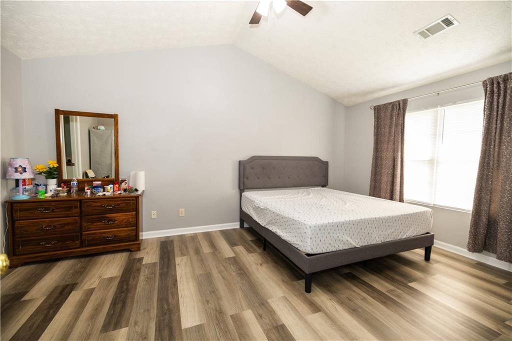599 Rivulett Court Lawrenceville, GA 30043 - Photo 11 of 31 a bedroom with a bed and a dresser