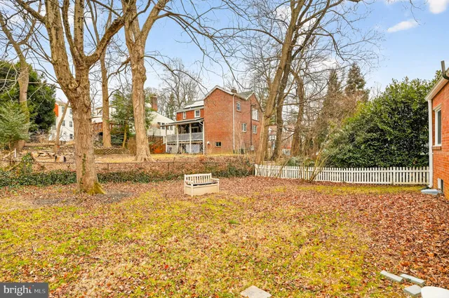 a white house with a large tree in front of it