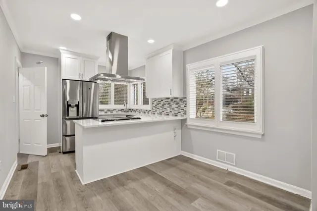 a kitchen with stainless steel appliances a sink and a refrigerator