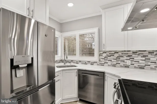 a kitchen with granite countertop a sink stove and cabinets