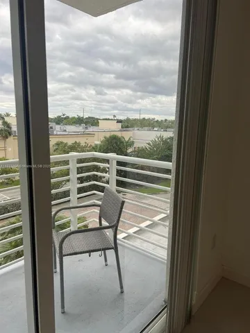 a view of a balcony with chair and table