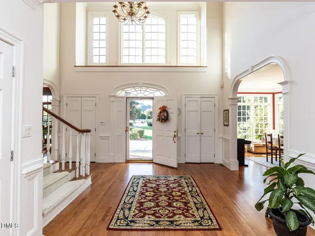 a spacious bedroom with a large window and a fireplace