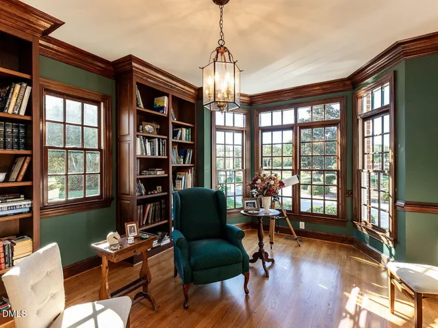 a living room with furniture a chandelier and a window