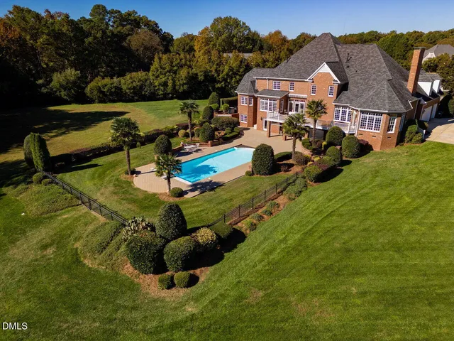 an entryway with dining room and wooden floor