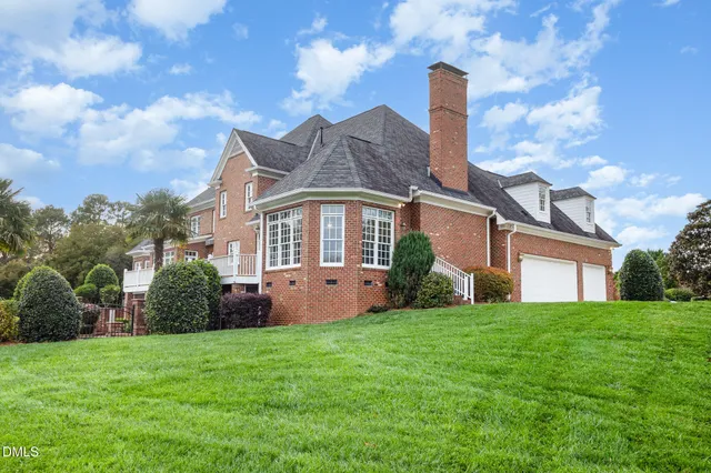 a living room with furniture and a large window with wooden floor