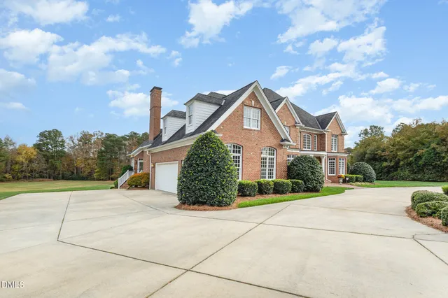 a view of a hallway view with furniture and a chandelier fan