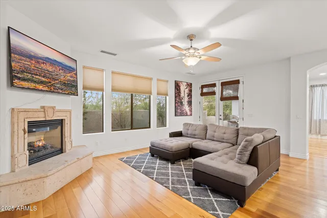 a living room with furniture a fireplace and a large window