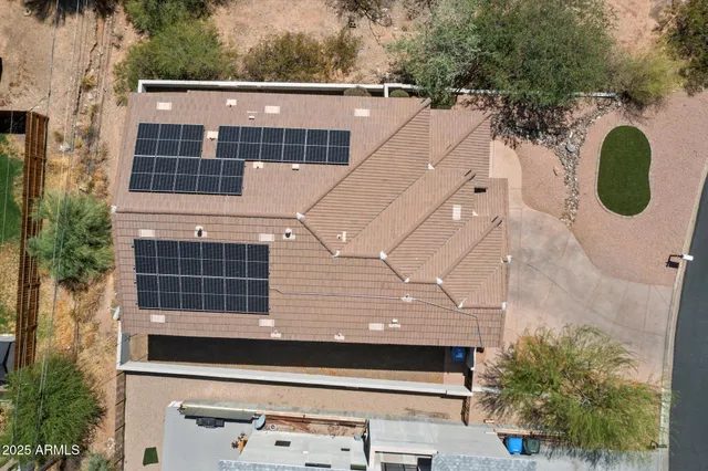 a view of a house with a backyard and trees