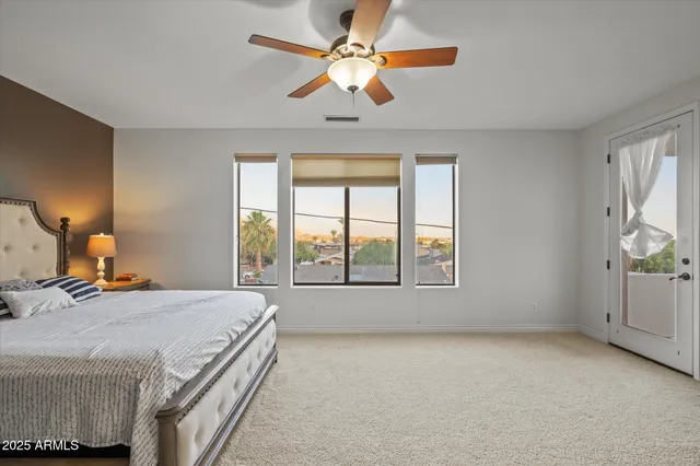 a bedroom with a large bed and a chandelier