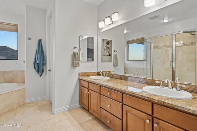 a bathroom with a granite countertop sink mirror and double