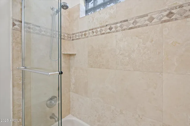 a bathroom with a glass shower door